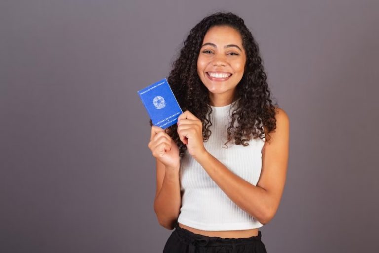 Jovem brasileira segurando carteira de trabalho clt work and social security card